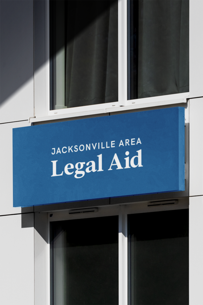 Exterior signage mockup for Jacksonville Area Legal Aid office, featuring new logo and branding in blue and white